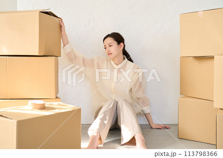 引越しの荷物に囲まれる女性 113798366