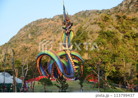 This Naga body is called Grandpa Phaya Sri Phet Khiri Mahamuni Srisutthonakarat Enshrined at Tham Chaeng Temple, it is a large and colorful Naga figure.  113799437