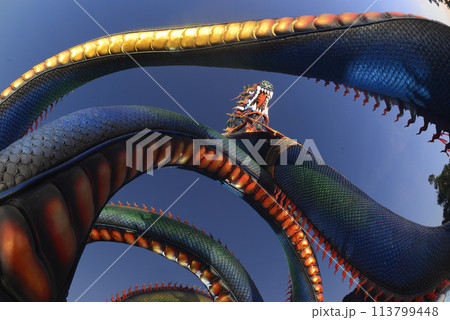 This Naga body is called Grandpa Phaya Sri Phet Khiri Mahamuni Srisutthonakarat Enshrined at Tham Chaeng Temple, it is a large and colorful Naga figure.  113799448