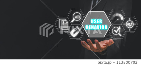 User behavior concept, Businessman hand holding user user data, analytics, user engagement, performance, target and research icon on virtual screen. 113800702