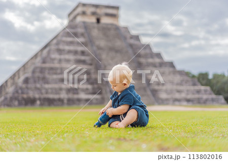 Baby traveler, tourists observing the old pyramid and temple of the castle of the Mayan architecture known as Chichen Itza these are the ruins of this ancient pre-columbian civilization and part of 113802016