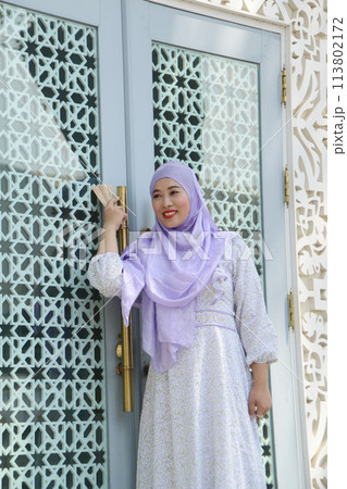 Portrait of young Asian woman wearing hijab posing. Portrait of young Asian woman wearing hijab posing. 113802172