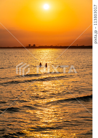【神奈川県】美しい夕日の光が降り注ぐ江の島から見た夕景 113803017