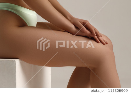 Tanned woman, perfect body shape. Fitness, weight Tanned woman, perfect body shape. Fitness, weight 113806909