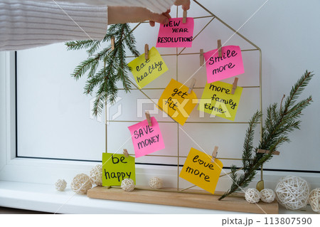 Woman creating dream board promises and aims. Preparation for new year new life new me. Visualizing wish list for 2025. Dreams plan action resolutions for coming year. Inspirational self improvement 113807590