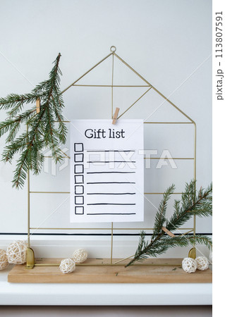 Preparation for winter holidays. GIFT LIST text on paper note. Celebration gifts and presents preparing Natural zero waste homemade Christmas decor. Happy new year Preparation for winter holidays. GIFT LIST text on paper note. Celebration gifts and presents preparing Natural zero waste homemade Christmas decor. Happy new year 113807591