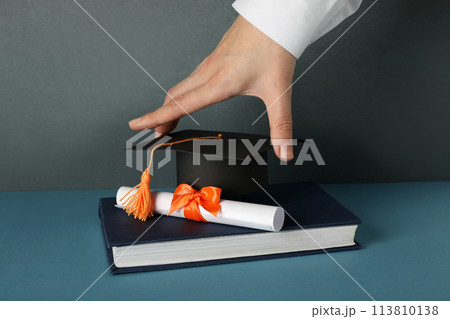 The hat of a university graduate, in his hands. The hat of a university graduate, in his hands. 113810138