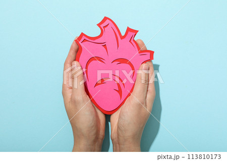 Heart on a blue background, the concept of treating cardiovascular diseases. 113810173