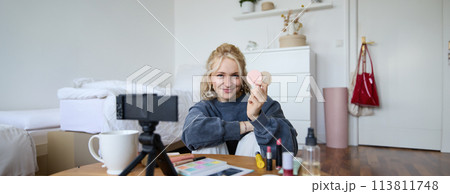 Portrait of beautiful blond woman, girl shows blushes, beauty products, recording video on digital camera, creating content for social media account, vlogger recommending items in vlog 113811748