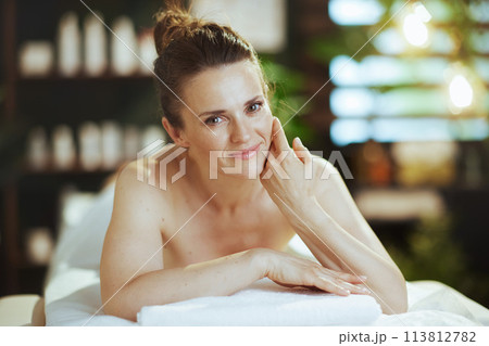 relaxed female in massage cabinet laying on massage table relaxed female in massage cabinet laying on massage table 113812782