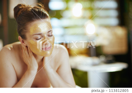 relaxed female in massage cabinet laying on massage table 113812805