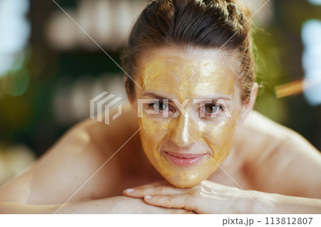 relaxed modern female in spa salon laying on massage table 113812807