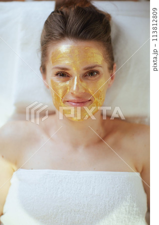 Upper view of relaxed woman in spa salon laying on massage table Upper view of relaxed woman in spa salon laying on massage table 113812809
