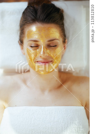 Upper view of relaxed woman in spa salon laying on massage table Upper view of relaxed woman in spa salon laying on massage table 113812810