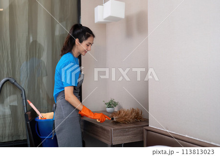 Cleaning service woman worker cleaning in bedroom at apartment. housekeeper cleaner feel happy and use feather duster wiping messy dirty for housekeeping housework or chores Cleaning service woman worker cleaning in bedroom at apartment. housekeeper cleaner feel happy and use feather duster wiping messy dirty for housekeeping housework or chores 113813023