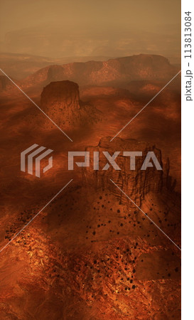 vast desert landscape with sand dunes, sparse vegetation, and a clear blue sky 113813084