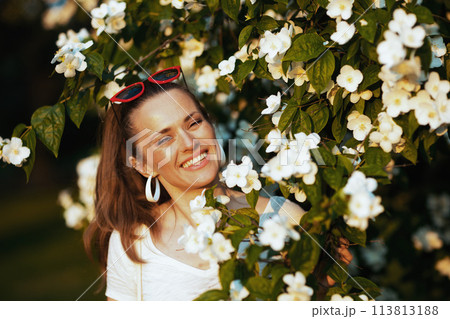 Portrait of happy young 40 years old woman in white shirt 113813188