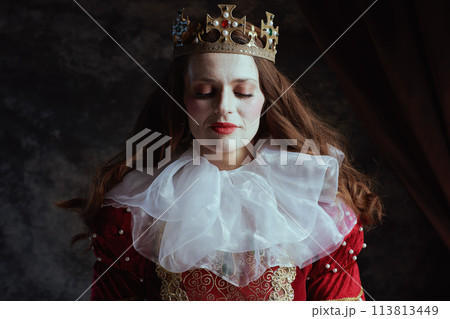 medieval queen in red dress with white collar and crown 113813449