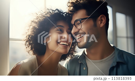 A happy couple is smiling and laughing together in the sunlight 113818393