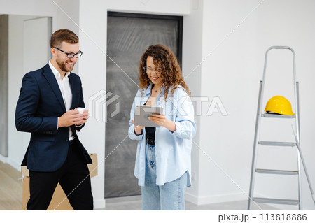 Young designer and customer businessman are designing interior standing with digital tablet in the new living room interior 113818886
