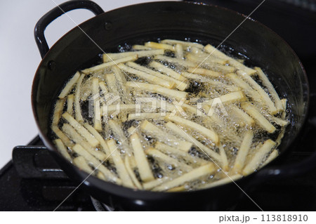 サツマイモを揚げる様子 113818910