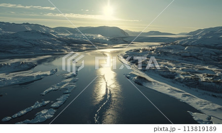 Frozen river surrounded by snowcovered mountains, under clear skies Frozen river surrounded by snowcovered mountains, under clear skies 113819189
