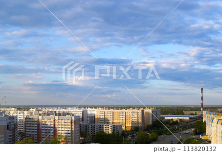 Top view of the city in the light of the sun under a cloudy sky at sunset 113820132