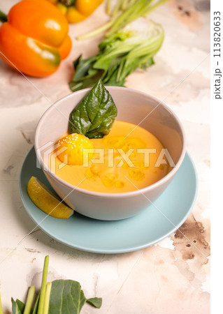 pumpkin cream soup with a slice of lemon in a plate on the table pumpkin cream soup with a slice of lemon in a plate on the table 113820633