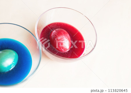 festive painted Easter eggs with colorful dyes on the table at home. 113820645