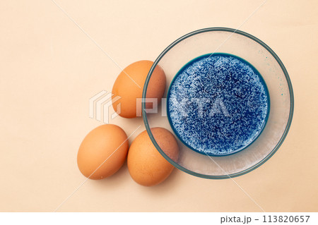 festive painted Easter eggs with colorful dyes on the table at home. 113820657