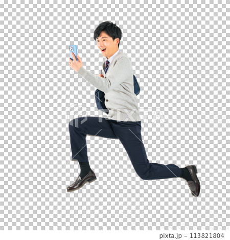 A male student in uniform jumping while looking at his smartphone. A transparent full-body photo PNG precisely cut by hand 113821804