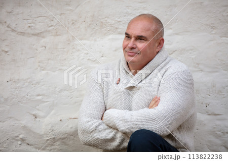 Handsome elderly man on a concrete wall background. 113822238