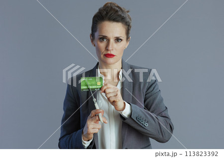 sad trendy 40 years old woman employee against gray background sad trendy 40 years old woman employee against gray background 113823392