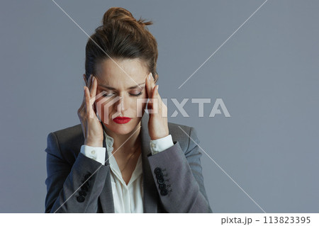 stressed business owner woman against grey 113823395