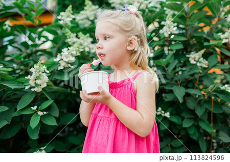 Child girl walks and have fun outdoor with cochlear implant on the head. Hearing aid and treatment concept. Copy space. Inclusion and people with disability 113824596