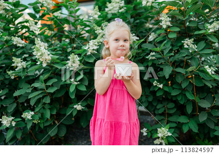 Child girl walks and have fun outdoor with cochlear implant on the head. Hearing aid and treatment concept. Copy space. Inclusion and people with disability 113824597
