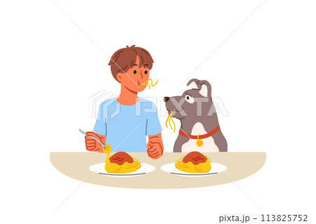 Little boy and dog eat spaghetti sitting at table, demonstrating friendship and trust Little boy and dog eat spaghetti sitting at table, demonstrating friendship and trust 113825752