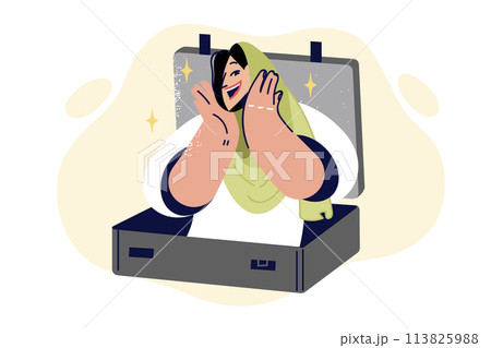 Muslim woman is getting ready to travel and tries on islamic headscarf, looking out of suitcase Muslim woman is getting ready to travel and tries on islamic headscarf, looking out of suitcase 113825988