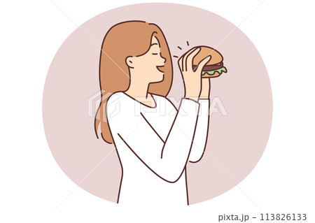 Happy woman eating hamburger 113826133