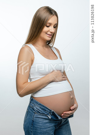 Cute pregnant woman with long hair on a white background Cute pregnant woman with long hair on a white background 113826198