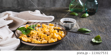Delicious pasta with minced meat and basil on a plate on the table web banner Delicious pasta with minced meat and basil on a plate on the table web banner 113827531