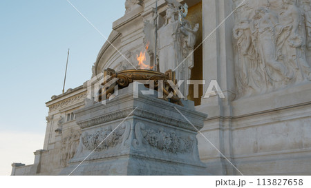 the flame of glory burning under a statue in Rome 113827658