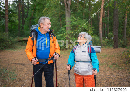 Hiking tourism adventure. Senior couple man woman enjoying outdoor recreation hiking in forest. Happy old people backpackers hikers enjoy walking hike trekking tourism active vacation beauty of nature 113827993