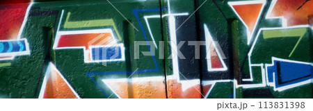 Colorful background of graffiti painting artwork with bright aerosol outlines on wall. Old school street art piece made with aerosol spray paint cans. Contemporary youth culture backdrop 113831398
