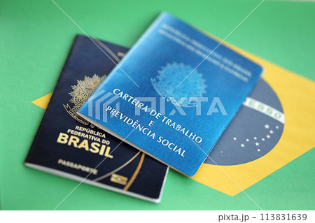 Passport of Brazil and work card with brazilian reais money bills on flag background close up 113831639