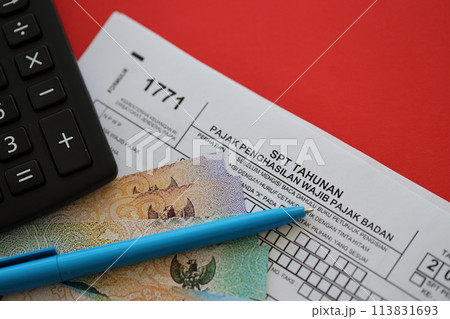 Indonesian tax form 1771 corporate taxpayers annual income tax return with pen lies on accountant table 113831693