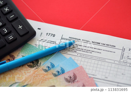Indonesian tax form 1770 Individual Income Tax Return and pen on table close up 113831695