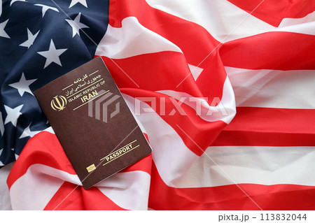 Red Islamic Republic of Iran passport on United States national flag background close up. Tourism and diplomacy concept Red Islamic Republic of Iran passport on United States national flag background close up. Tourism and diplomacy concept 113832044