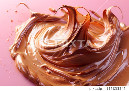 A luscious chocolate swirl elegantly adorns a soft pink surface, creating a captivating blend of colors and textures. 113833343