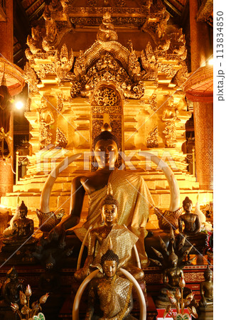 Luang Phor Phet, the principal Buddha image and beautiful Buddha statues that are hundreds of years old inside the chapel at Wat Phra That Chom Thong Worawihan. Located in Chiang Mai ,Thailand. 113834850